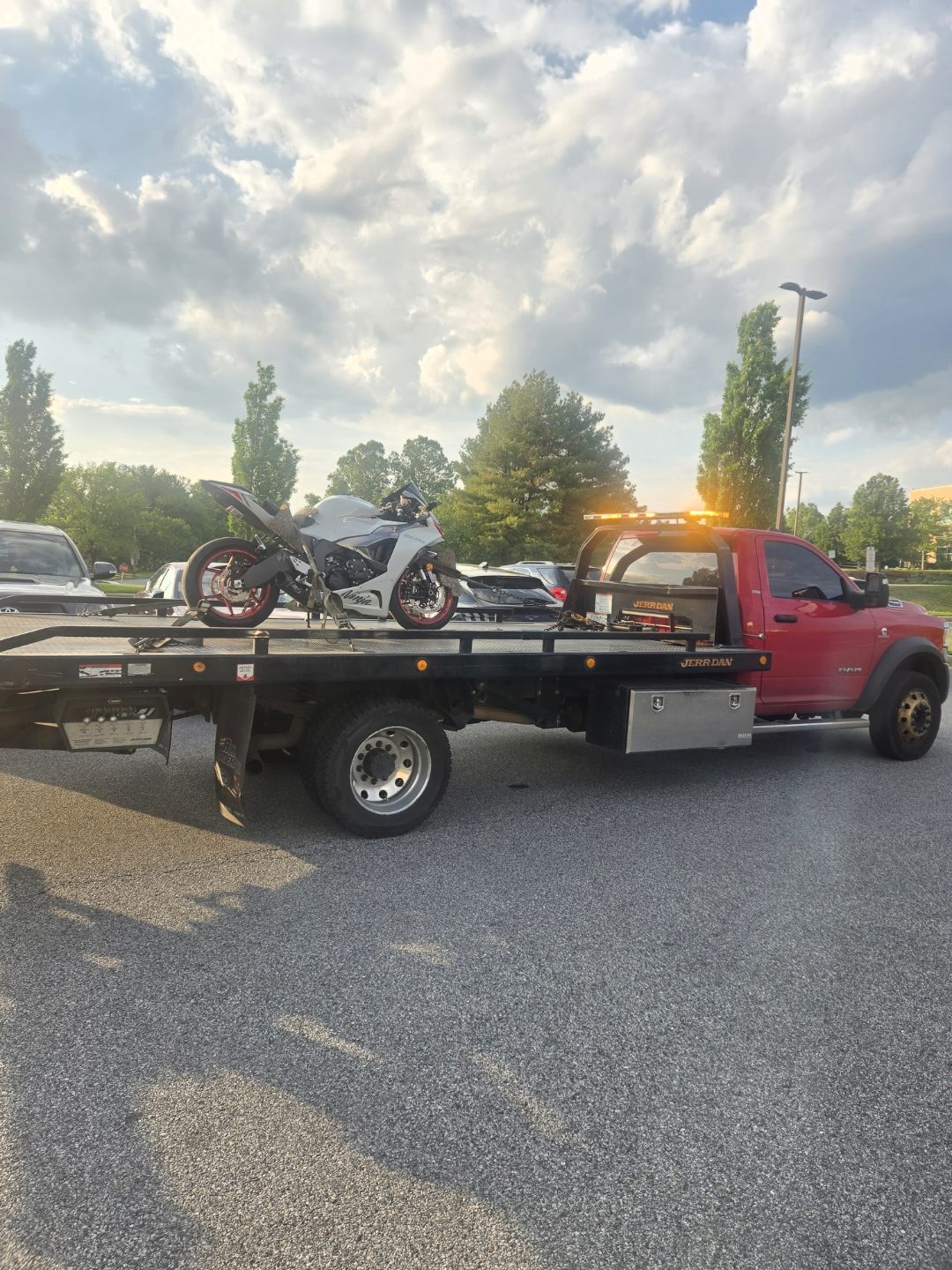 Motorcycle strapped to a Jerr-Dan flatbed for towing in Baltimore