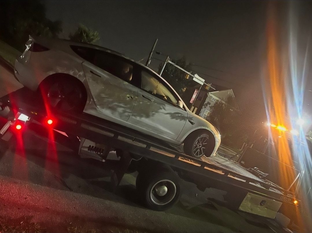 Tesla being flatbed towed at night in Baltimore, Maryland